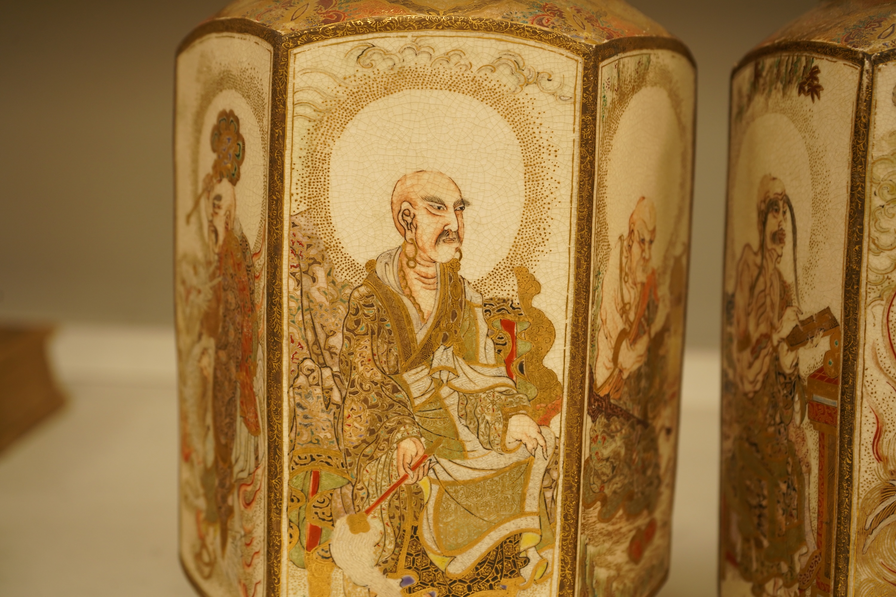 A pair of Japanese Satsuma 'rakan' vases, Meiji period, 26cm high
